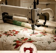 Long arm quilting machine stitching a quilt